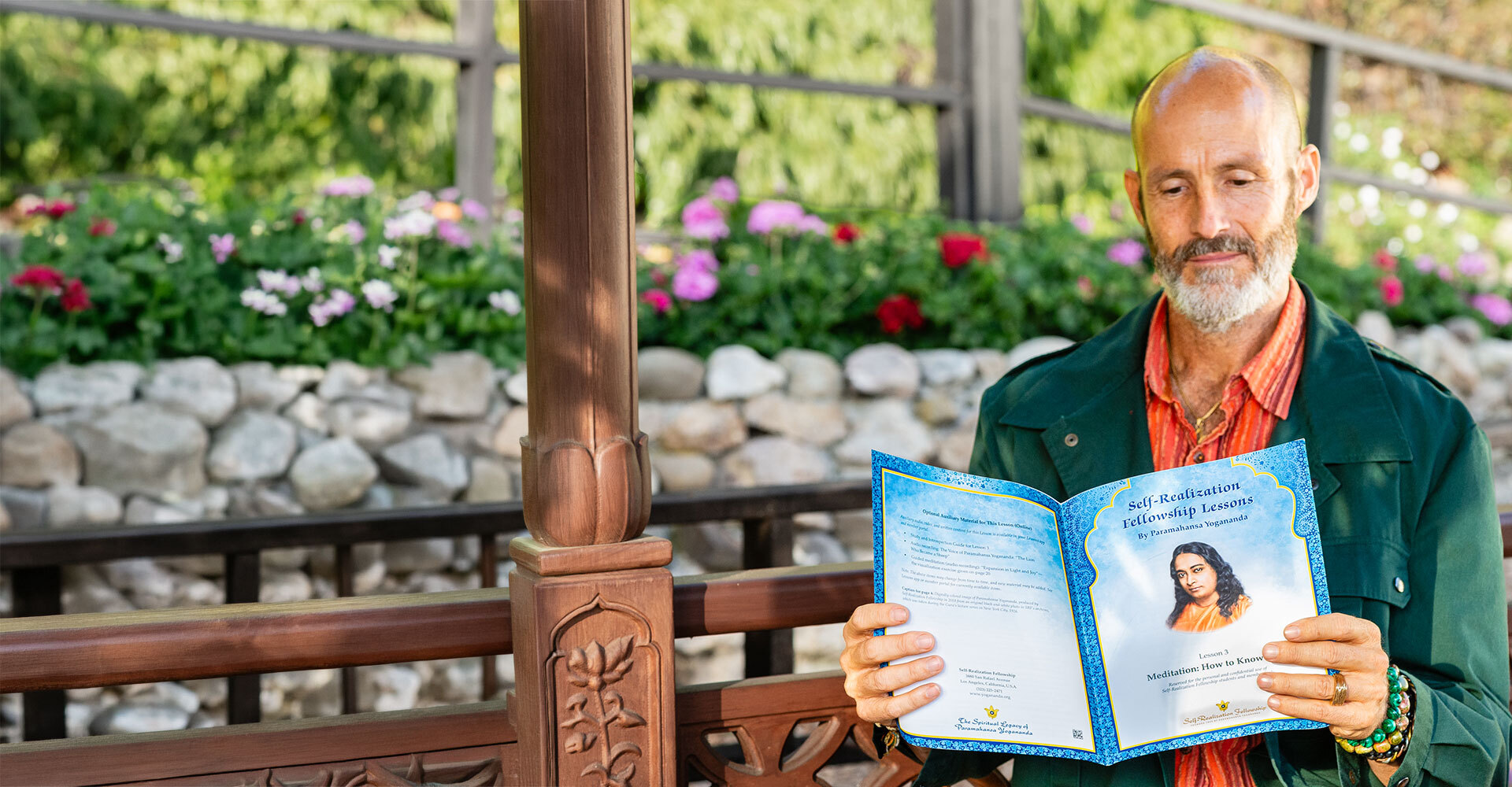 Devotee reading SRF Lessons at Lake Shrine banner 1