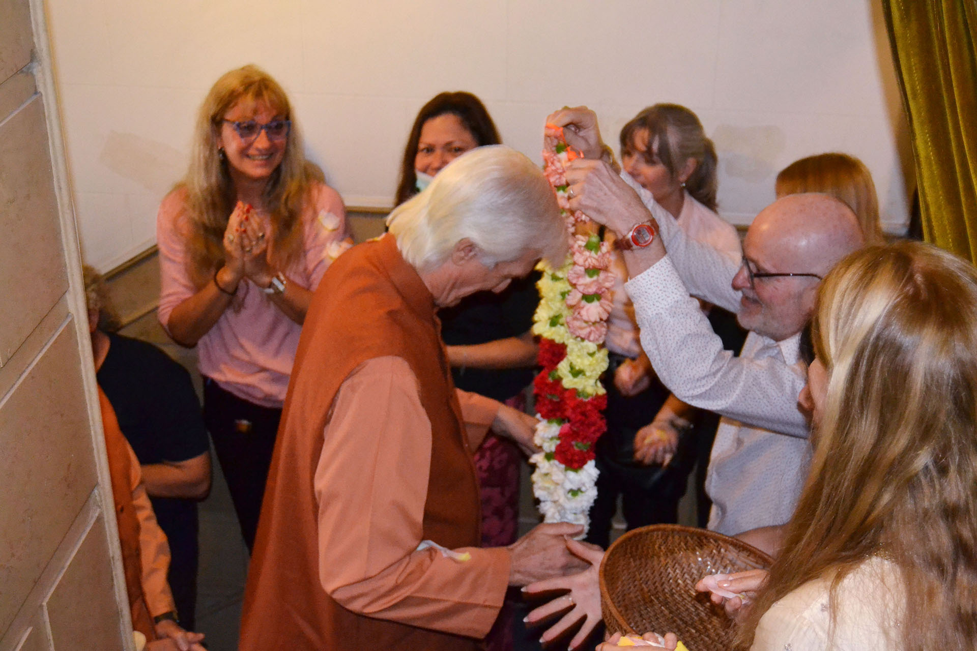 A senior devotee garlands Brother Chidananda, officially welcoming him to the Buenos Aires Center.