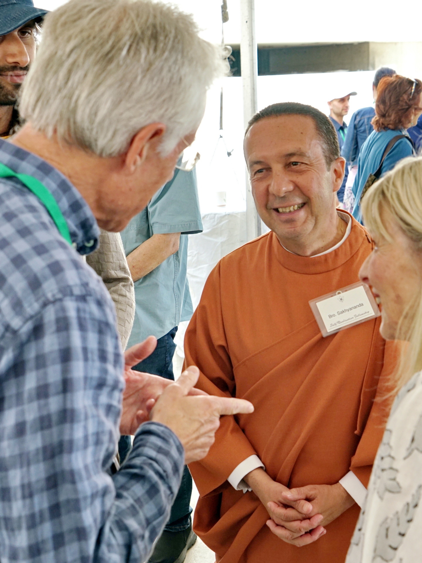 Brother Sakhyananda talks with SRF members at the Open House event.