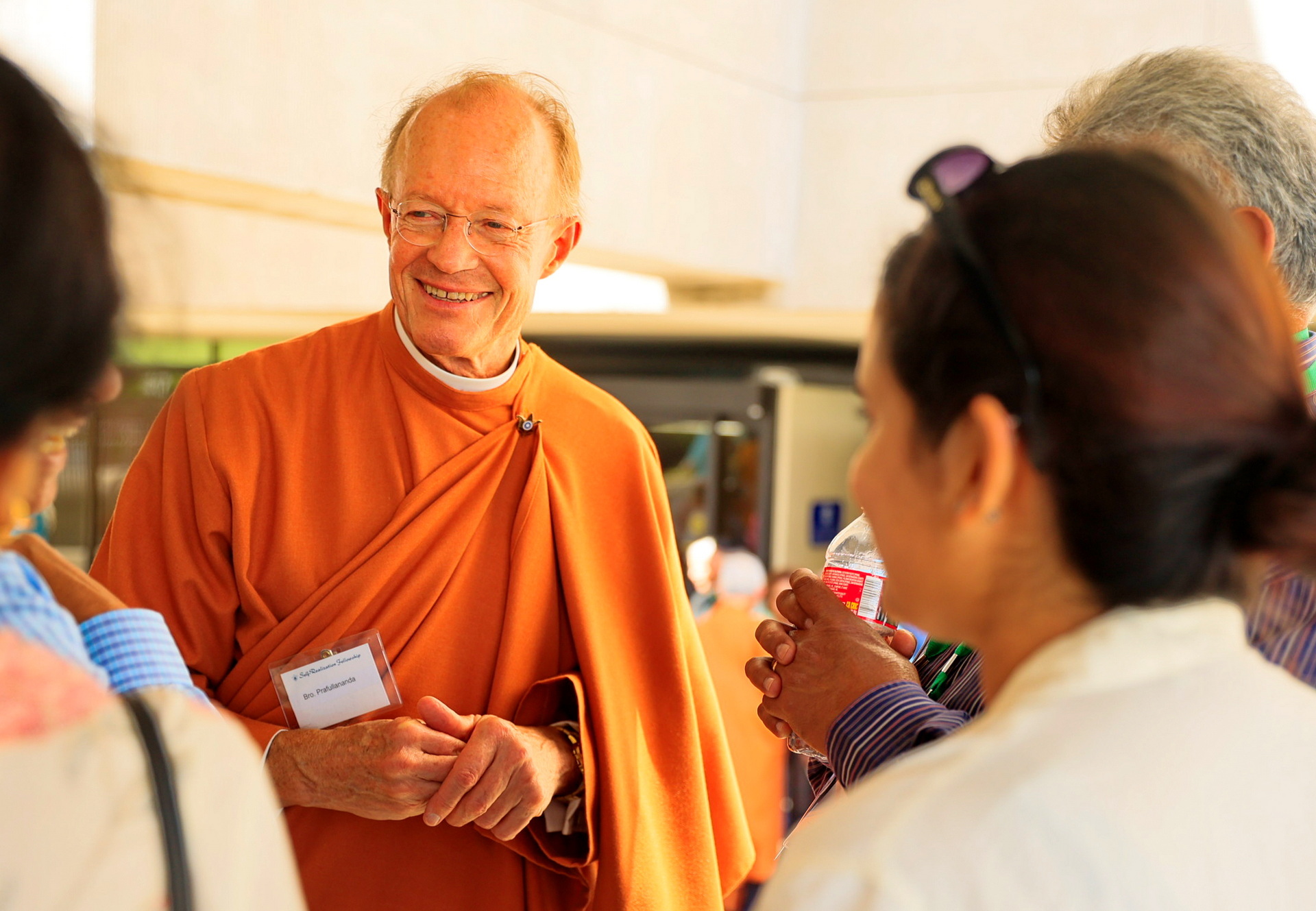 Brother Prafullananda greets members.