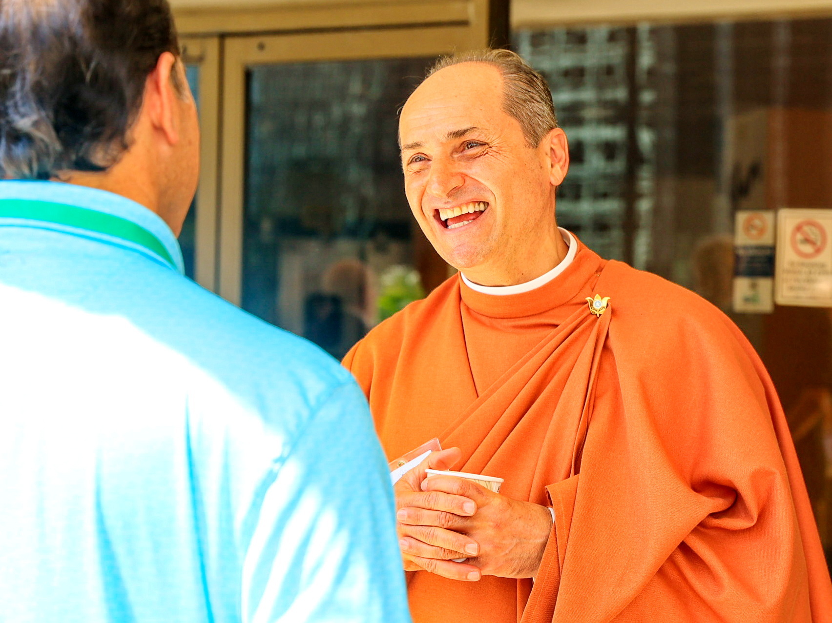 Brother Tyagananda hosts a participant.