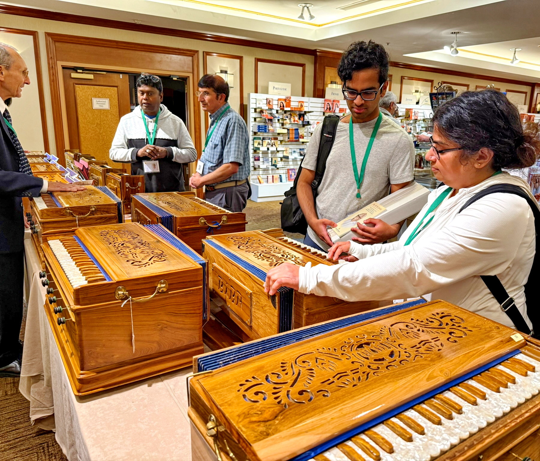 In the Books and Gifts room, interest was shown in the harmoniums on display as helpful aids in devotional chanting.