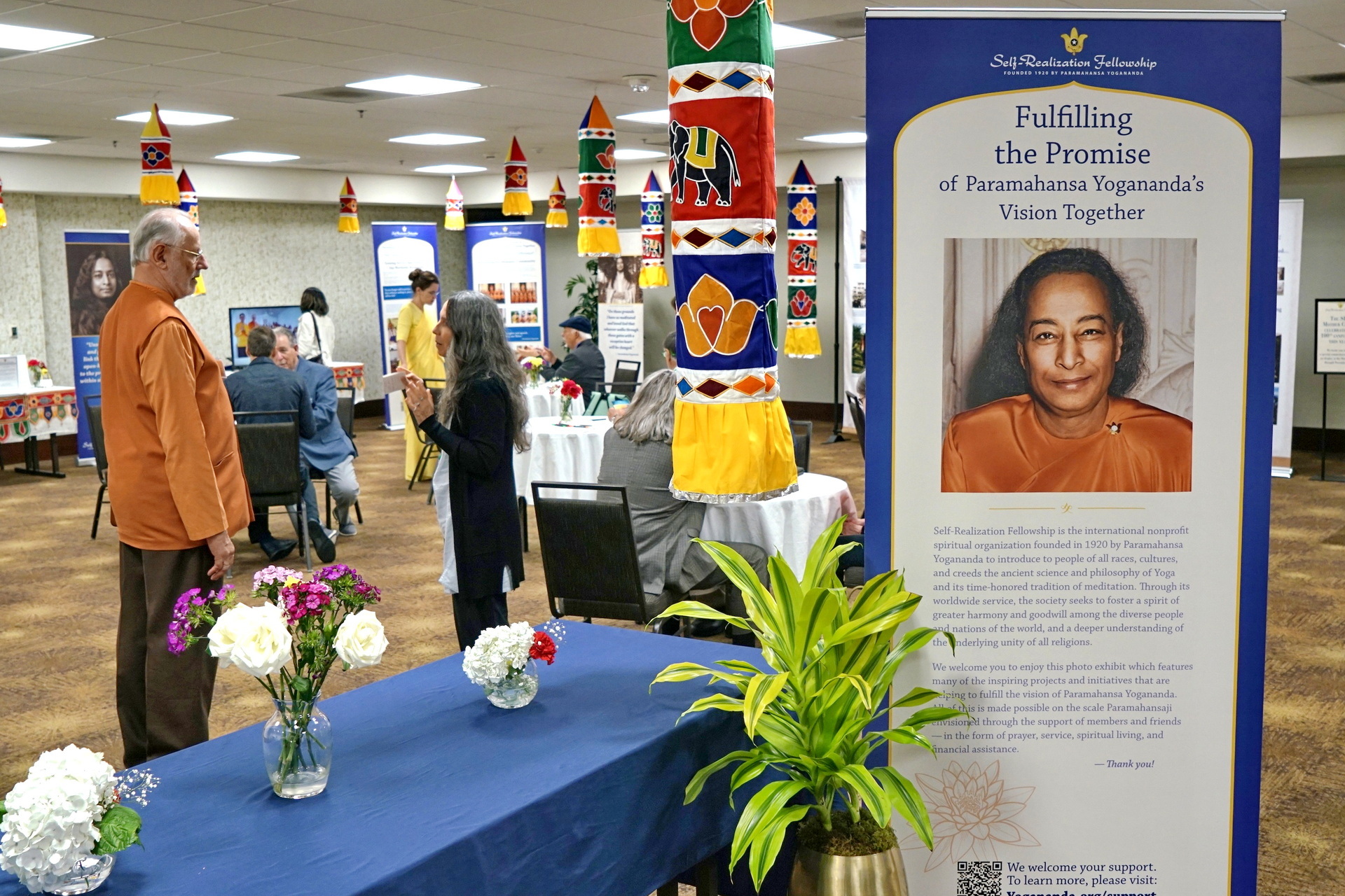 Brother Kalyanananda speaks with a devotee in the Department of Philanthropic Planning room.