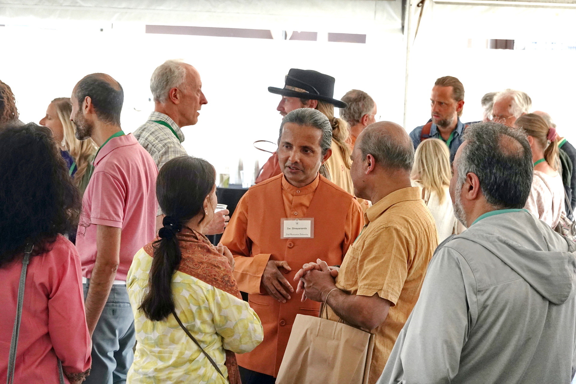 Swami Shreyananda, a YSS monk visiting Paramahansaji’s SRF ashrams, speaks with Convocation participants at the Open House event.