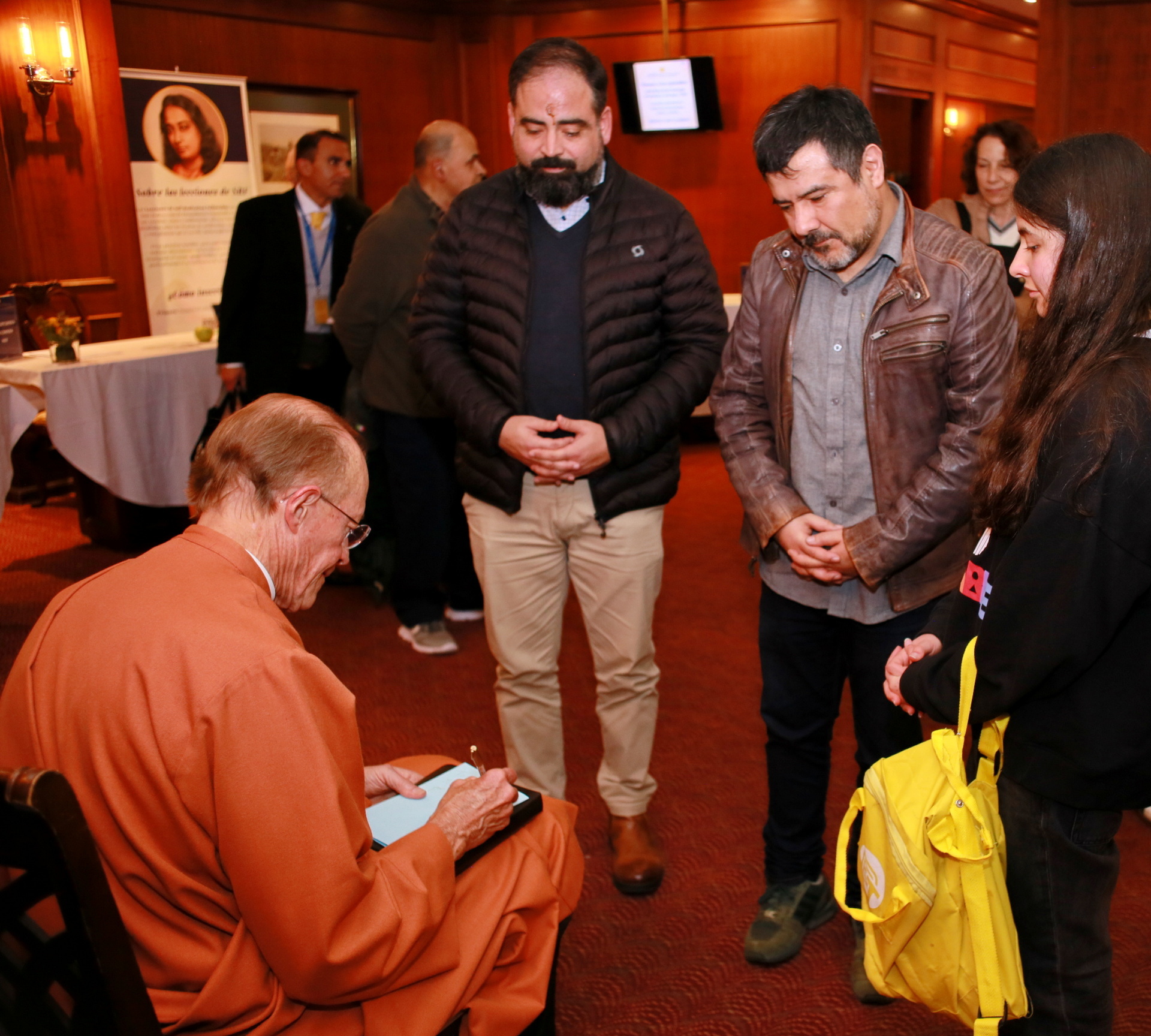 As a memento of the weekend, a member asks for a message to be written in one of Paramahansaji's publications.