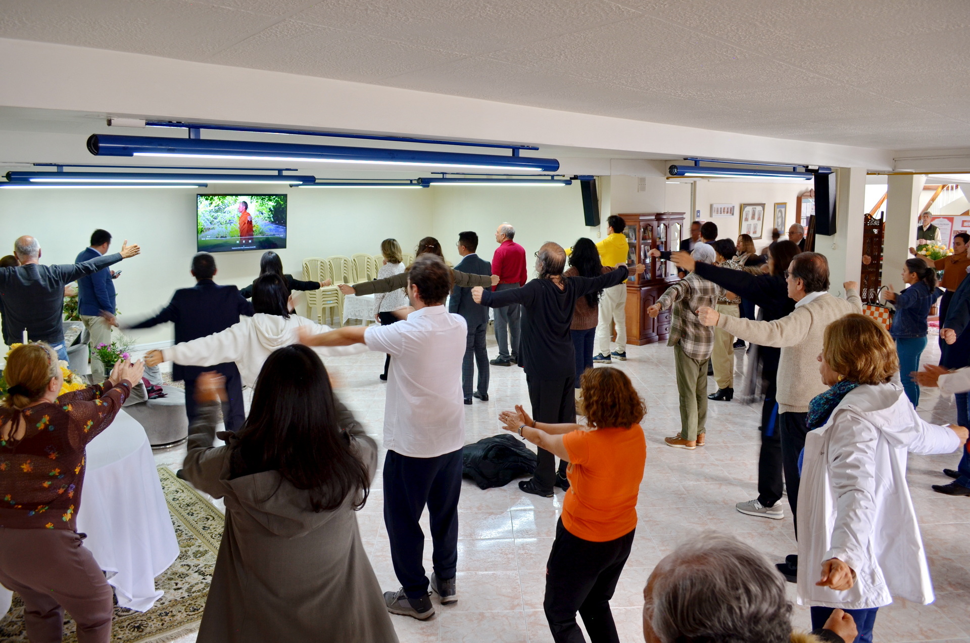 Devotees practice the Energization Exercises before a group meditation.