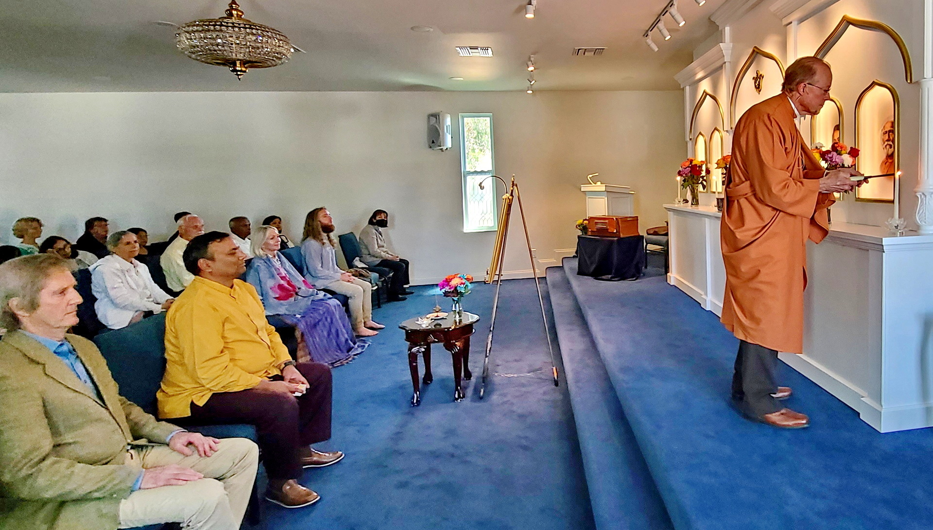 Brother Prafullananda lights the candles on the altar while dedicating the new chapel at the Tampa Meditation Group.