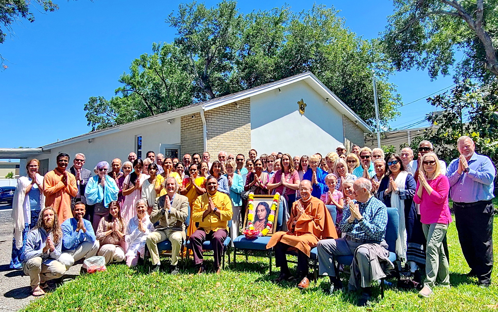 The SRF monks and members gather for a picture outside the new chapel .