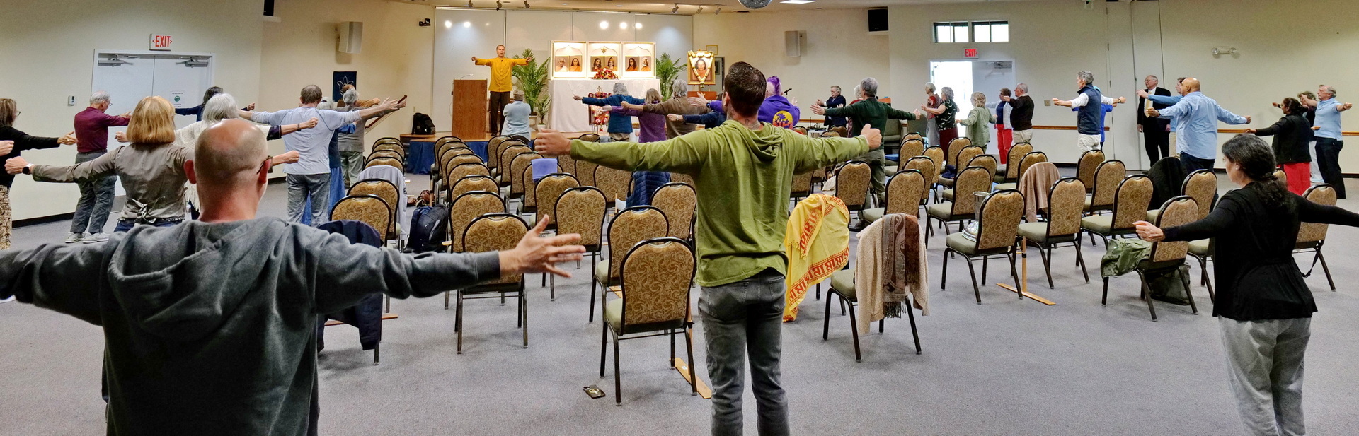 Brahmachari Preston leads practice of the Energization Exercises before a group meditation.