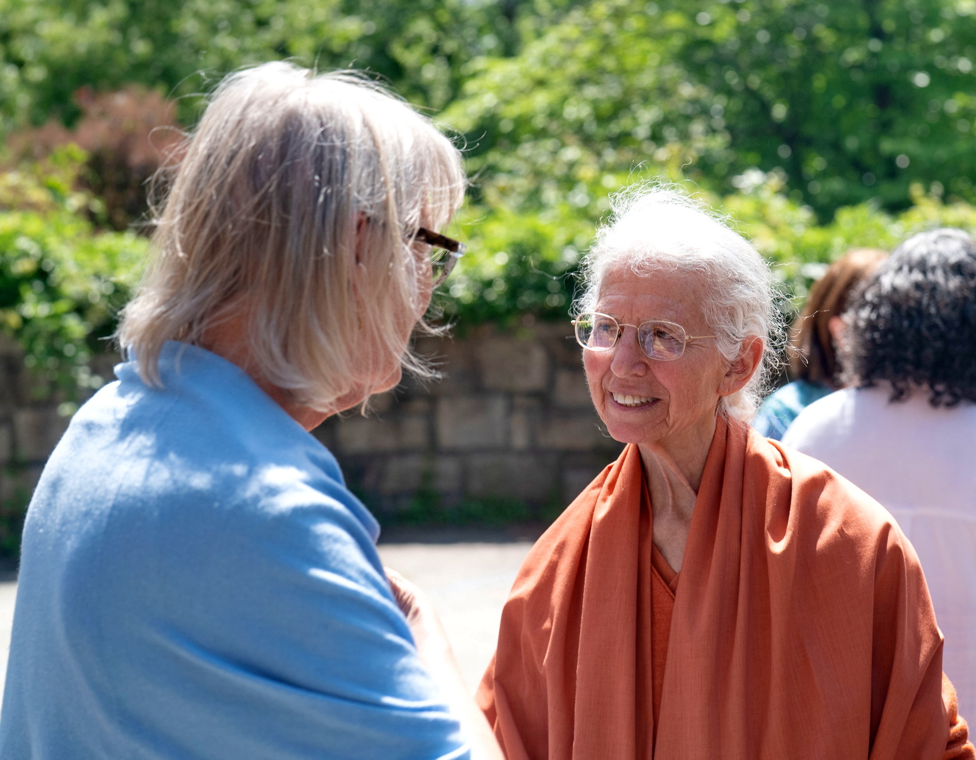 Sister Usha greets a member after the program.