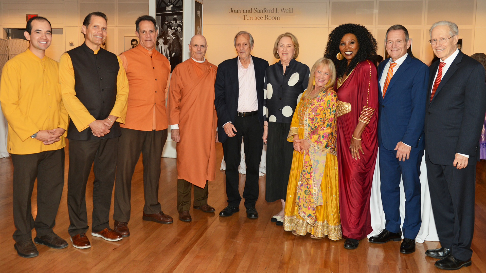 The performers and event organizers from the SRF New York City Center pose for a photo during the reception following the evening's program.