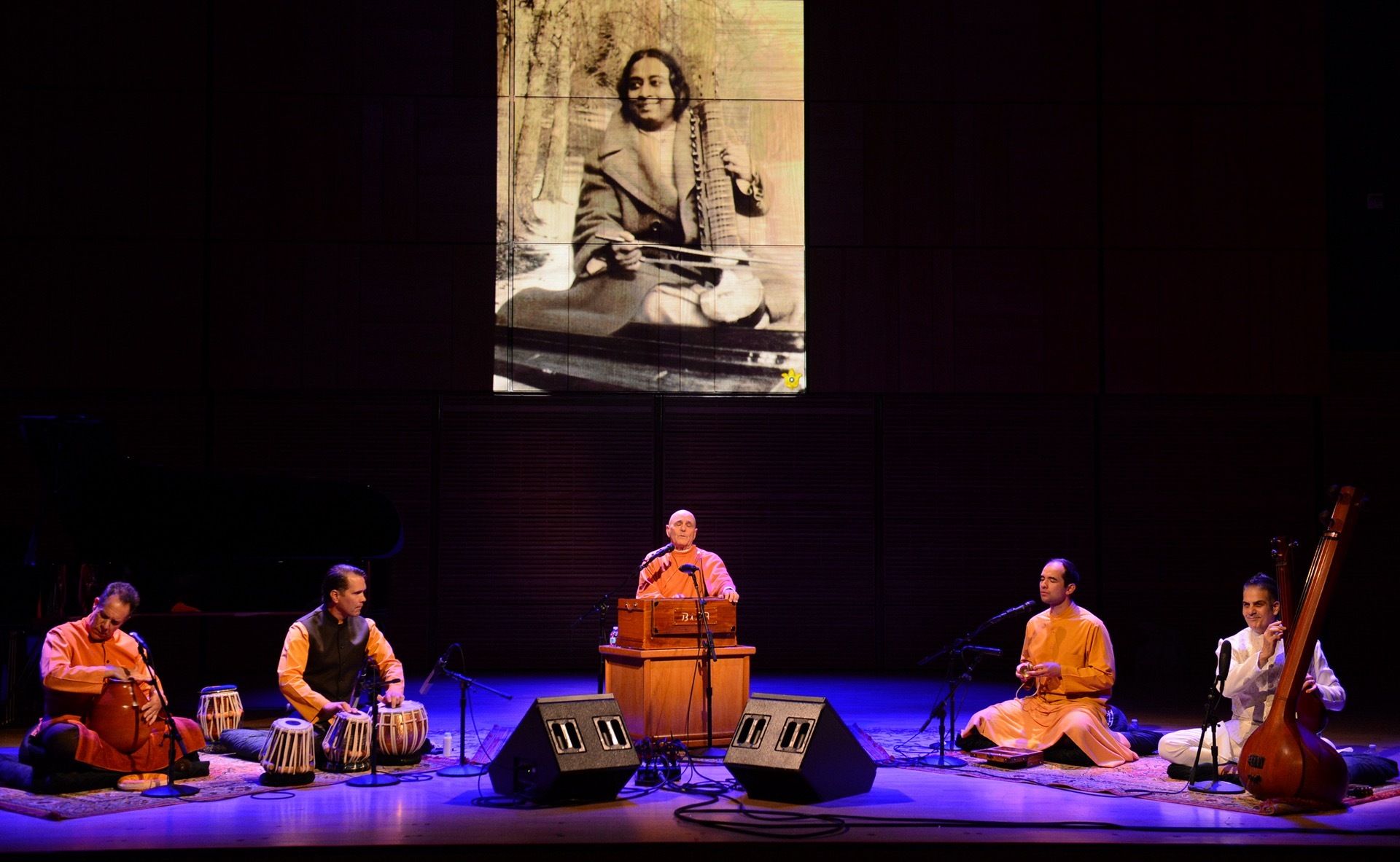 From the harmonium, Brother Devananda led the Self-Realization Fellowship monks' kirtan group playing ghatam, tabla, and cymbals, with SRF member Joey Dee Cirillo on tanpura.