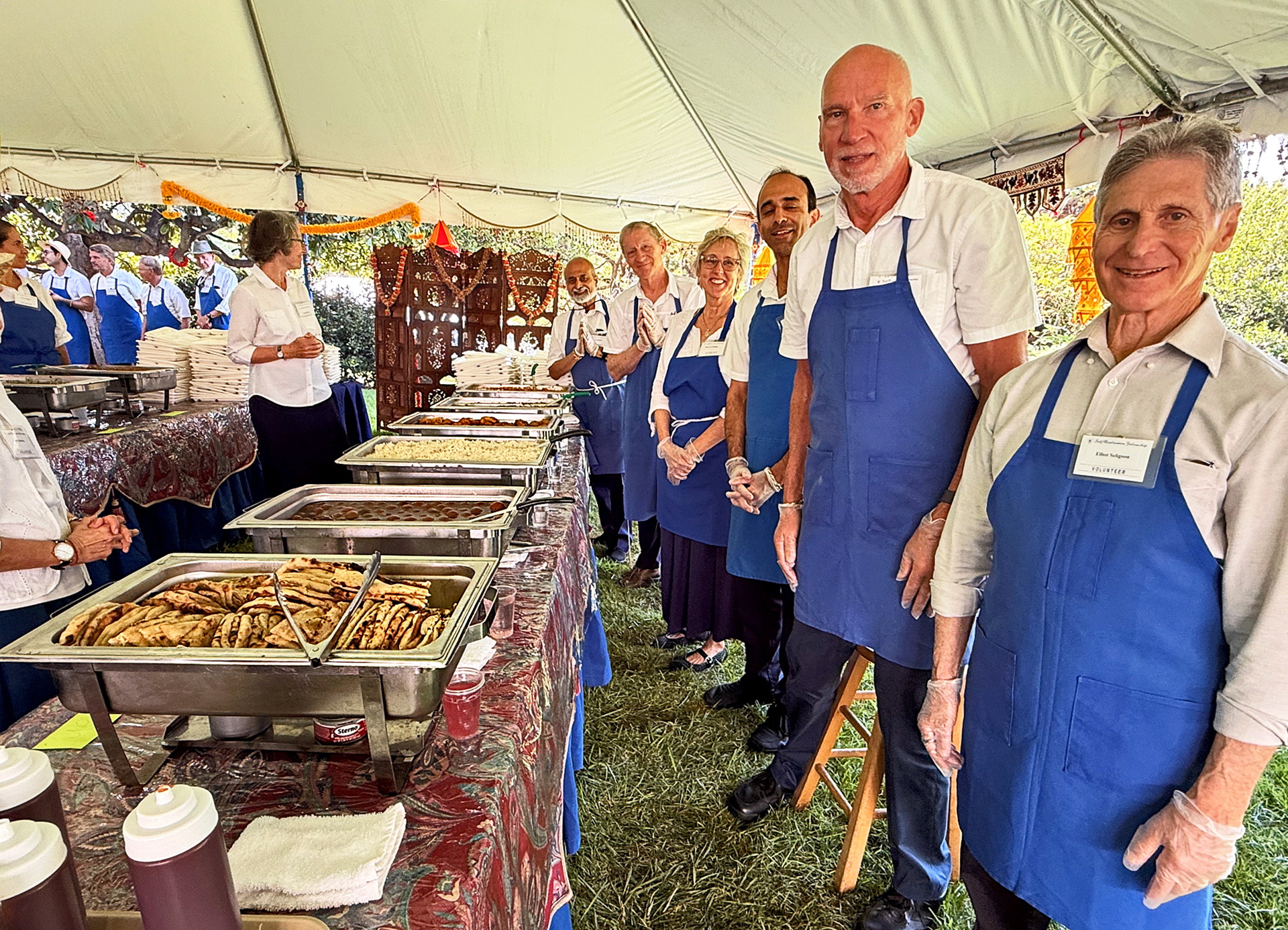 Volunteers serve an Indian lunch to pilgrimage attendees.