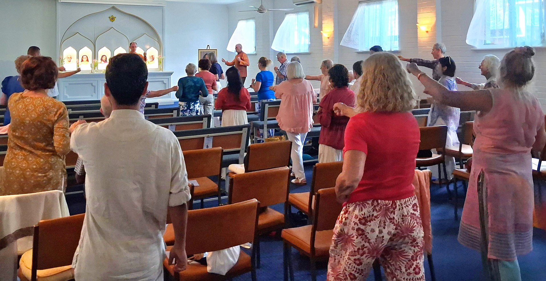In Perth, Brother Bhimananda conducts the practice of Paramahansa Yogananda's Energization Exercises before a group meditation...