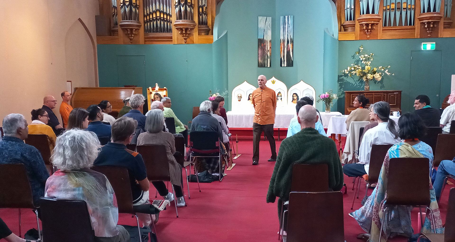 ....and Brother Devananda speaks to the attentive participants.