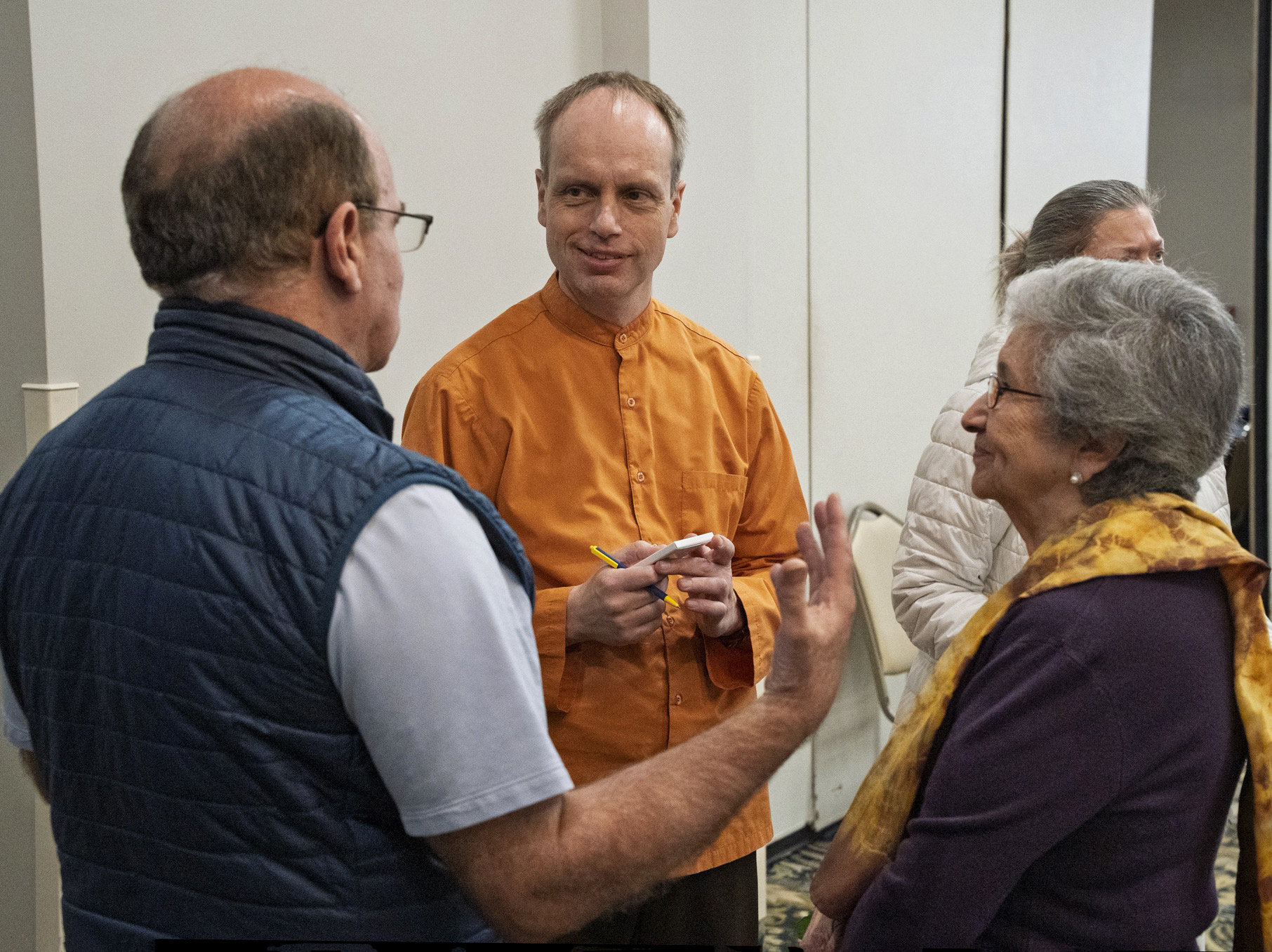 Members enjoy speaking with Brother Dhyanananda.