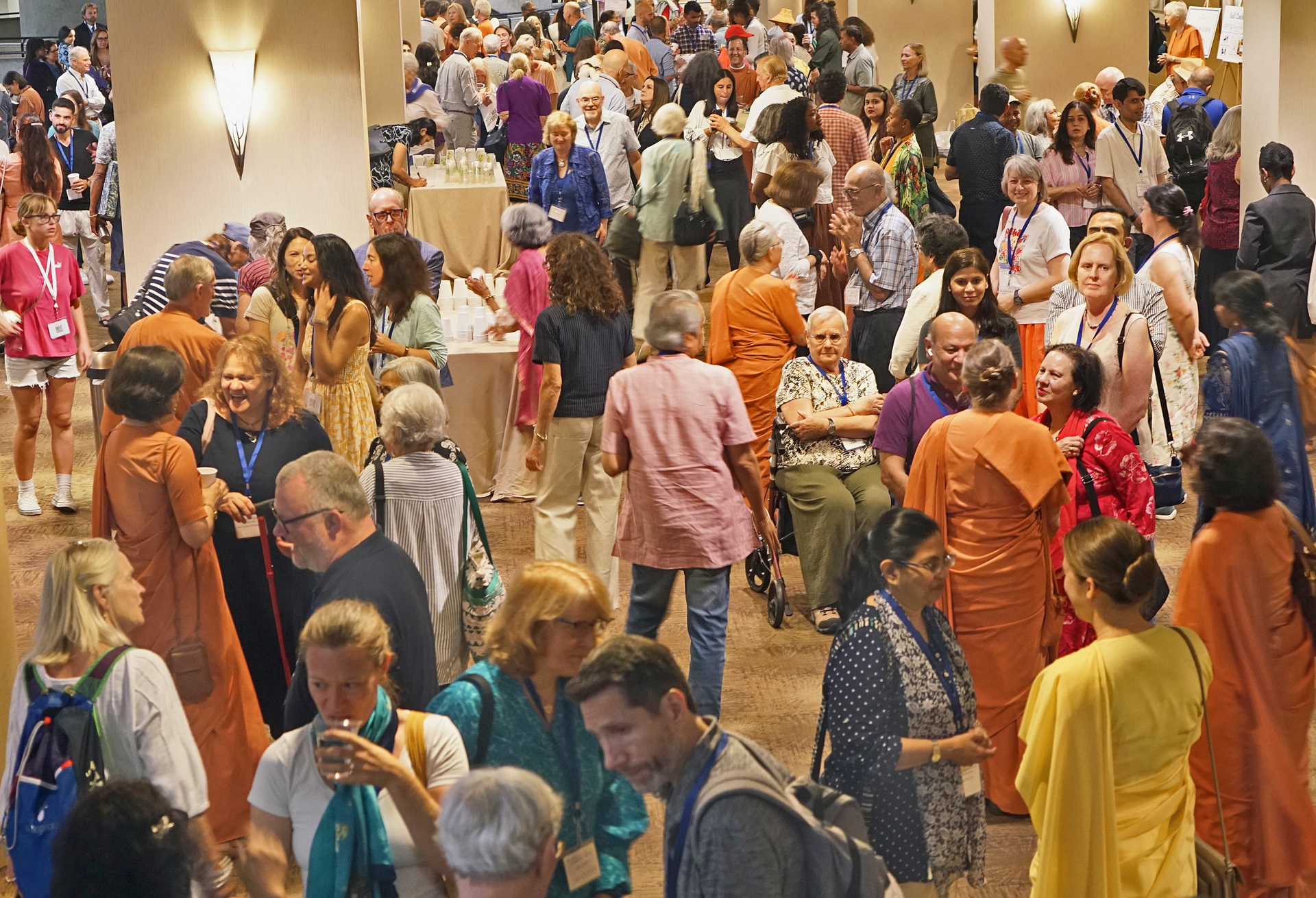 SRF monks and nuns extending a warm welcome to participants at the Open House gathering on the first day of Convocation.