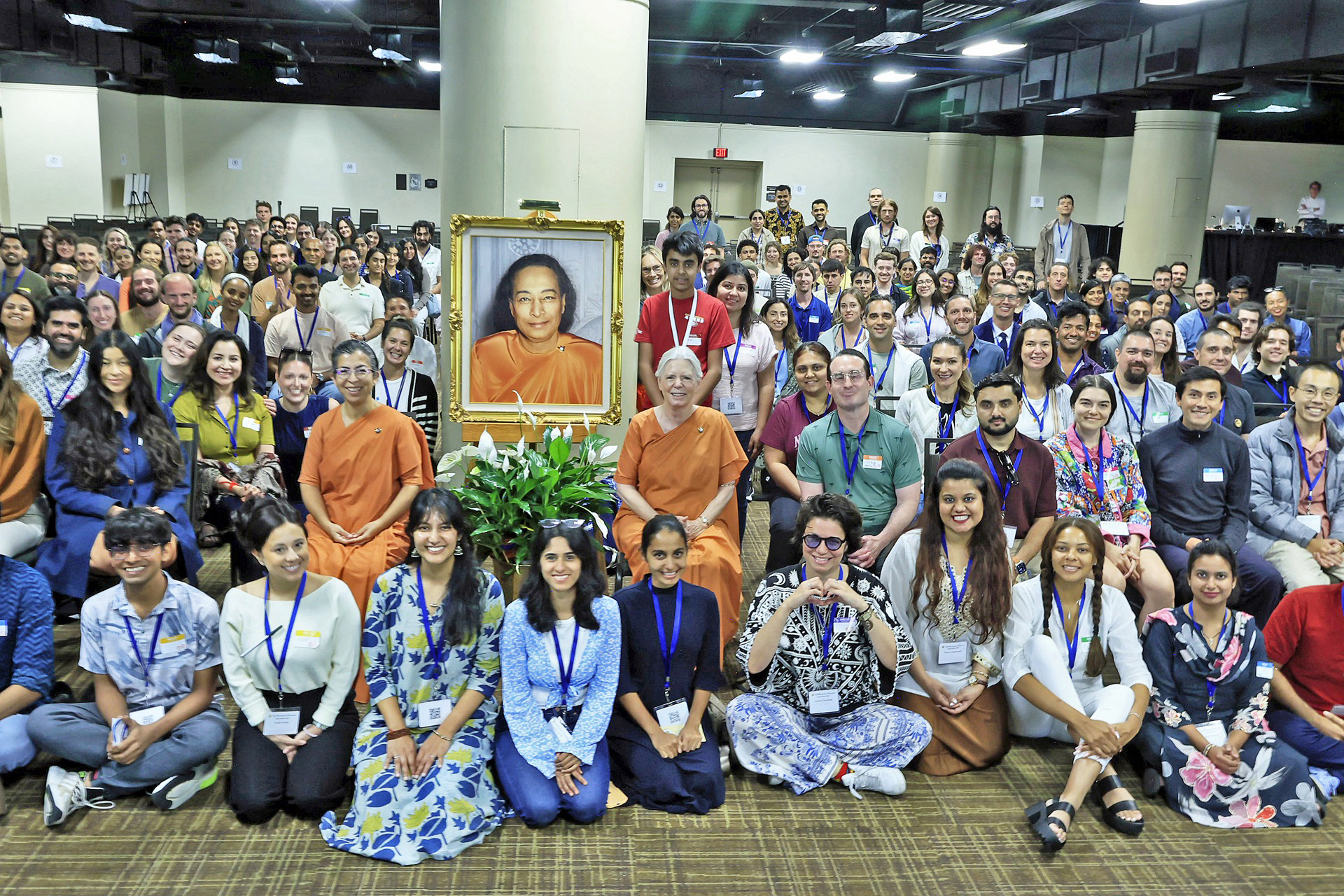 A large gathering of SRF young adults participate in an interactive class with SRF monks and nuns.
