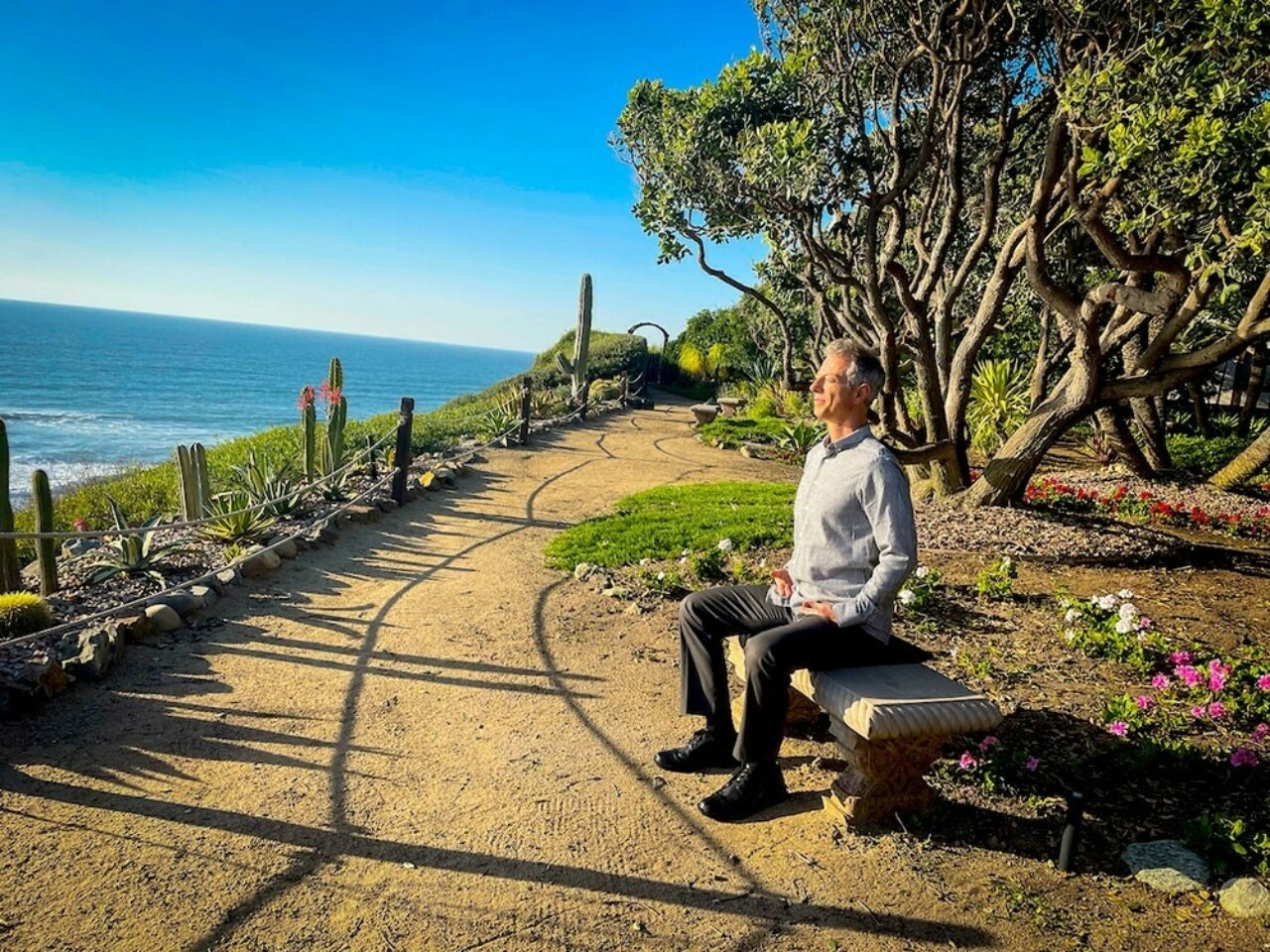 Man meditating at the SRF Meditation Gardens in Encinitas
