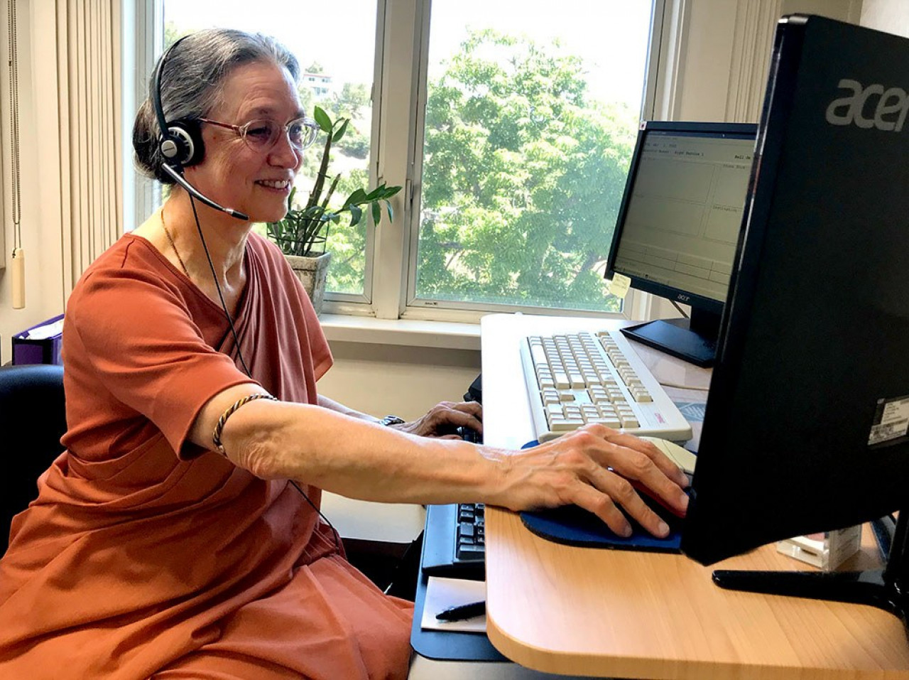 SRF nun answers phones at the Mother Center