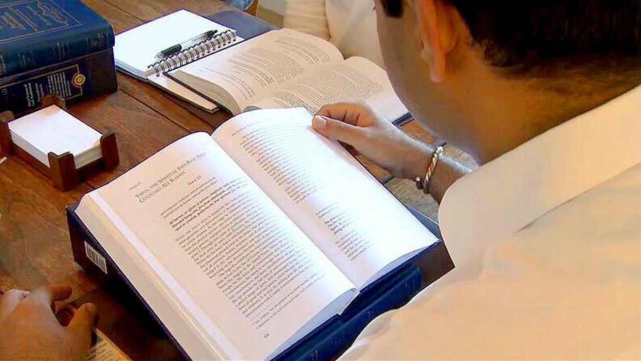 Devotee reading God Talks With Arjuna