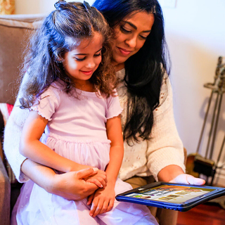 Mother daughter watching Lake Shrine video