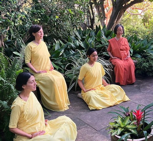 Nuns meditating in garden square